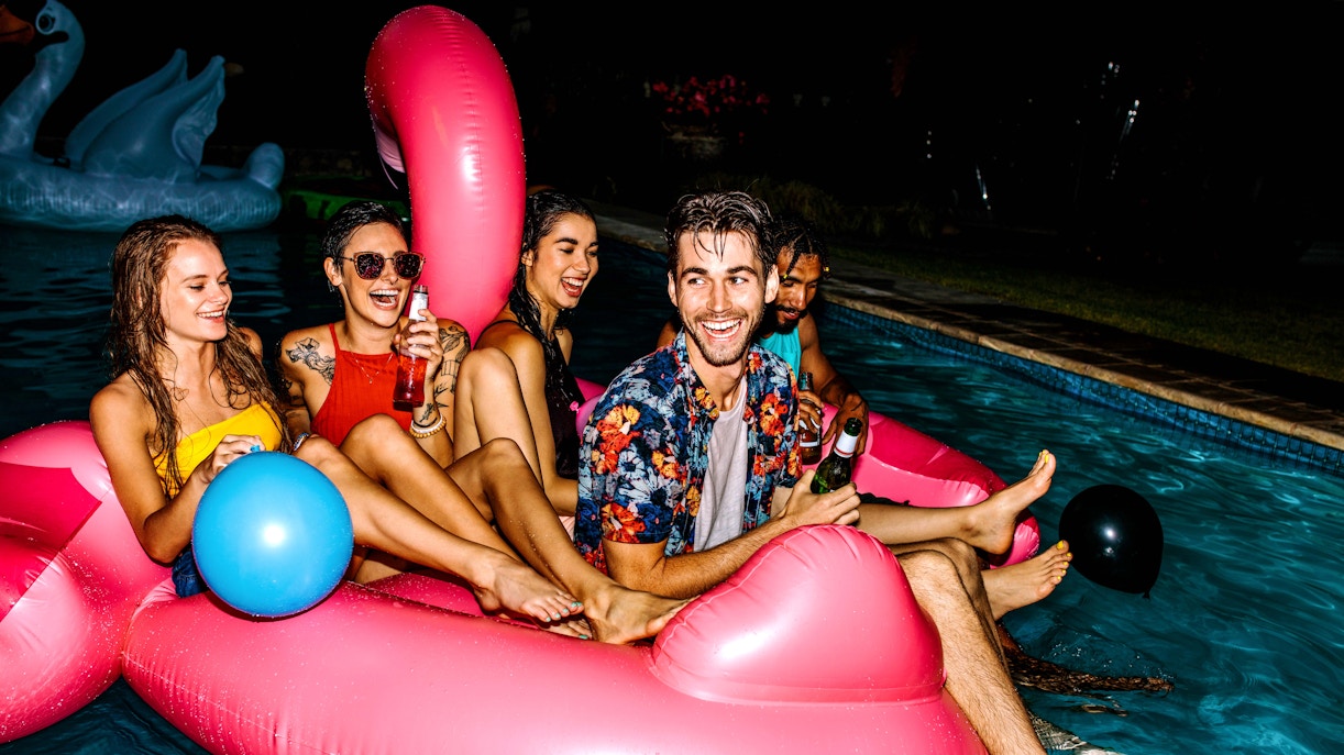 Budapest river cruise with partygoers enjoying the city skyline at night.