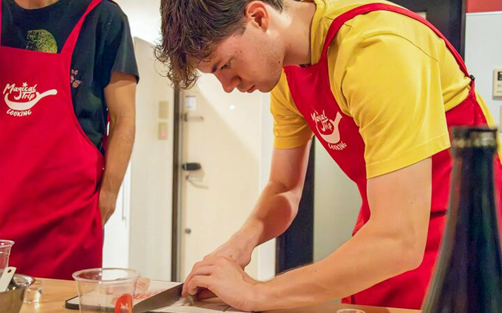 Participant preparing ingredients during Tokyo Izakaya-style cooking class.