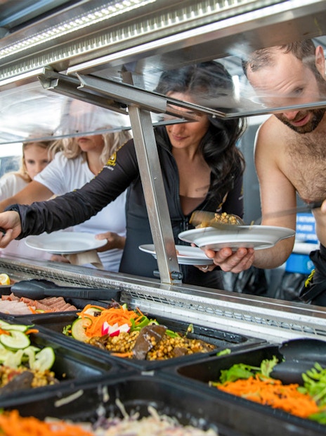 Guests enjoying buffet lunch on Cairns to Great Barrier Reef cruise.