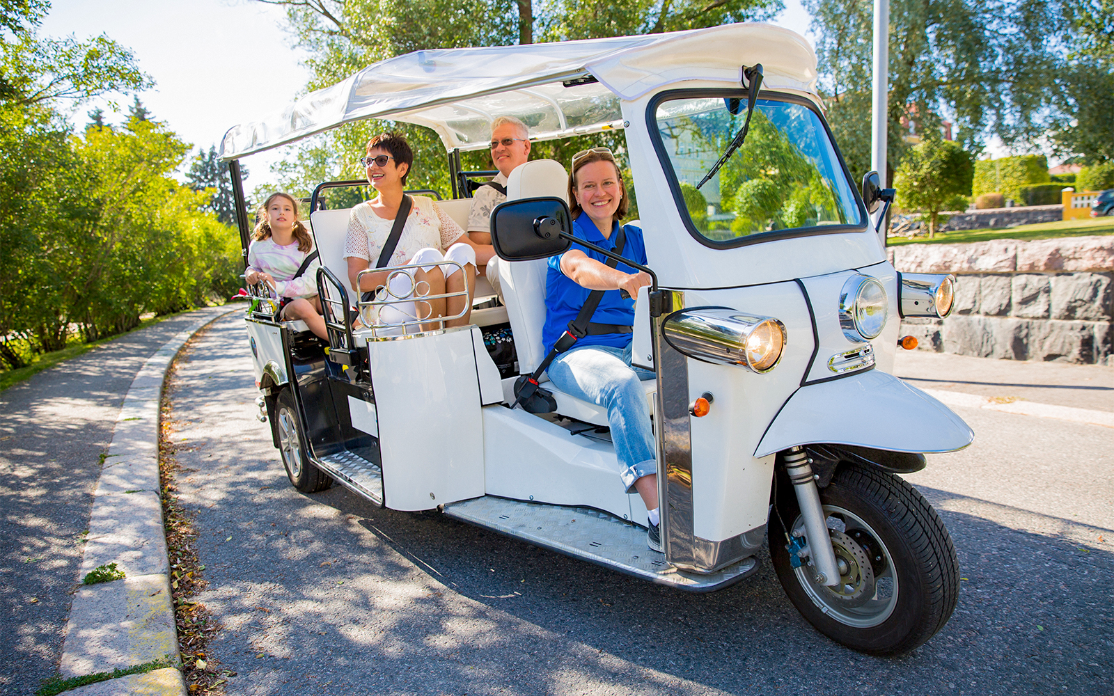 Tourists in tuk-tuk electric car