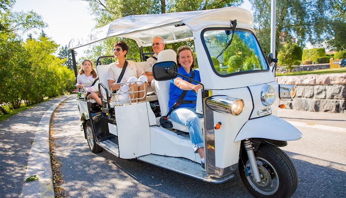 Tourists in tuk-tuk electric car
