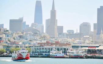 Golden Gate Bay Cruise boat with San Francisco skyline in the background.