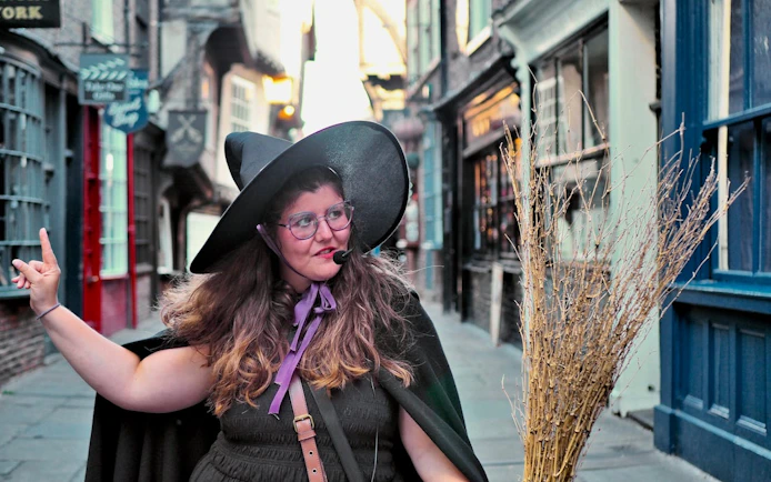Guide in witch costume leading York Old Town walking tour.