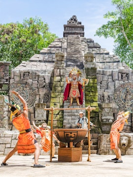 Performers in traditional costumes at Pachamaya show, Marine Safari Bali, with ancient stone backdrop.