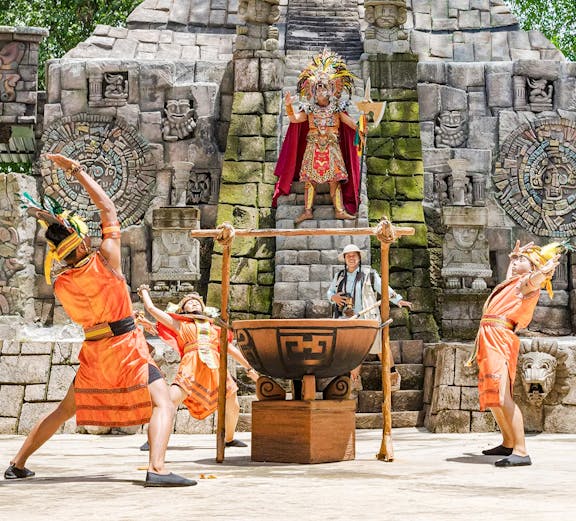 Performers in traditional costumes at Pachamaya show, Marine Safari Bali, with ancient stone backdrop.