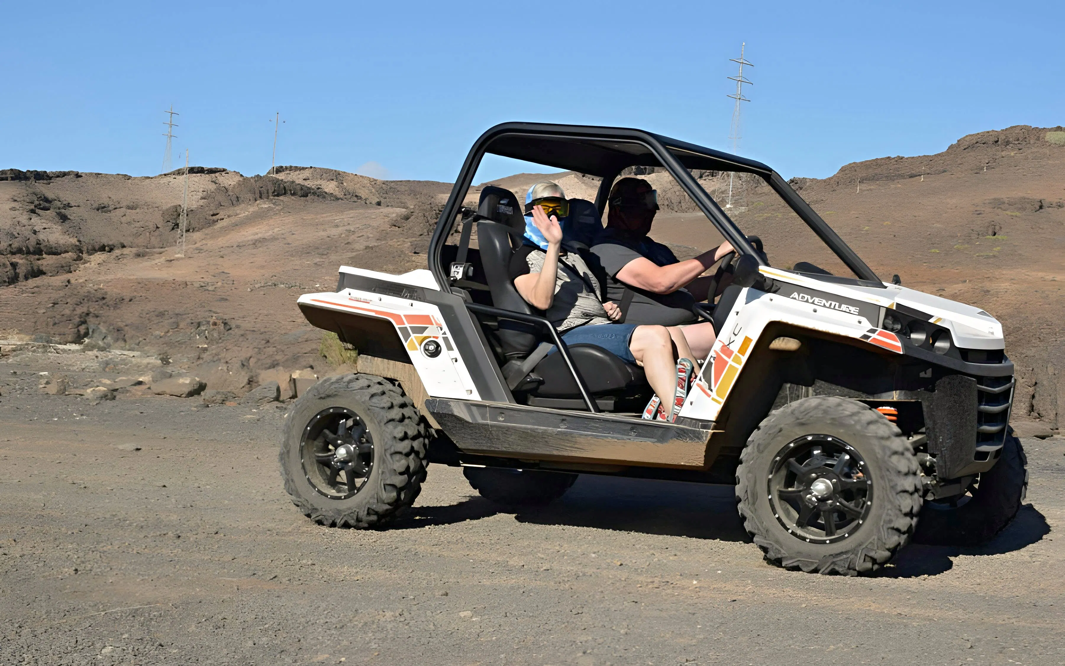 Off-road buggy driving through rocky terrain in Gran Canaria.