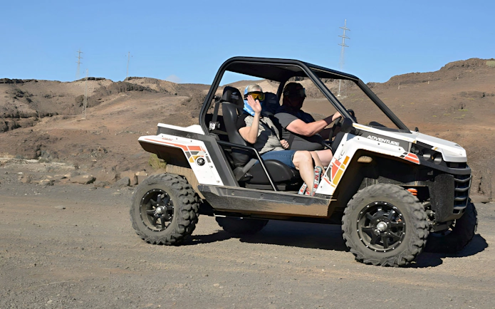 Off-road buggy driving through rocky terrain in Gran Canaria.