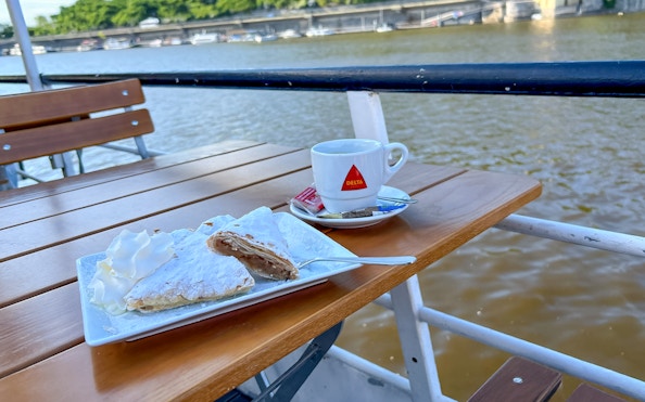 Hot drink and dessert on a table during a one-hour river cruise.
