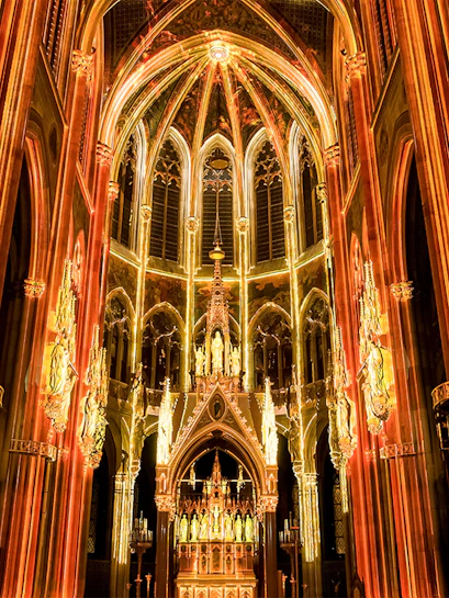 Gothic cathedral interior with illuminated arches and altar, Sainte-Chapelle, Paris.