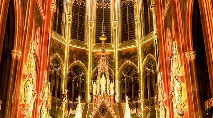 Gothic cathedral interior with illuminated arches and altar, Sainte-Chapelle, Paris.