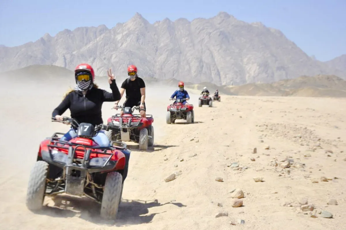 Quad biking adventure in the desert near Hurghada with mountains in the background.