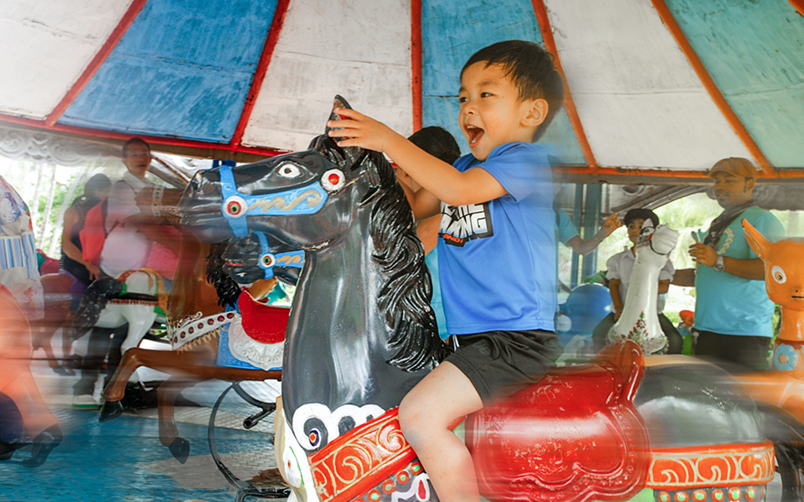 children enjoying rides at small world at siam amazing park