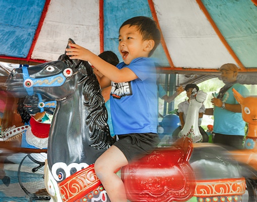 children enjoying rides at small world at siam amazing park