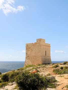 Ancient stone tower near Hagar Qim, Malta, overlooking the sea.