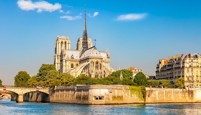 Notre Dame during golden hour with a river view.