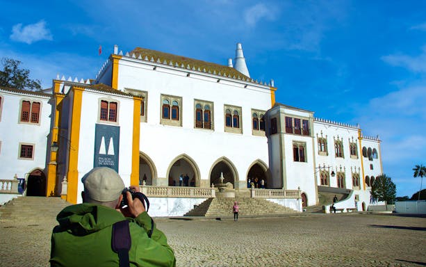 Sintra National Palace with visitor taking photos during guided walking tour.