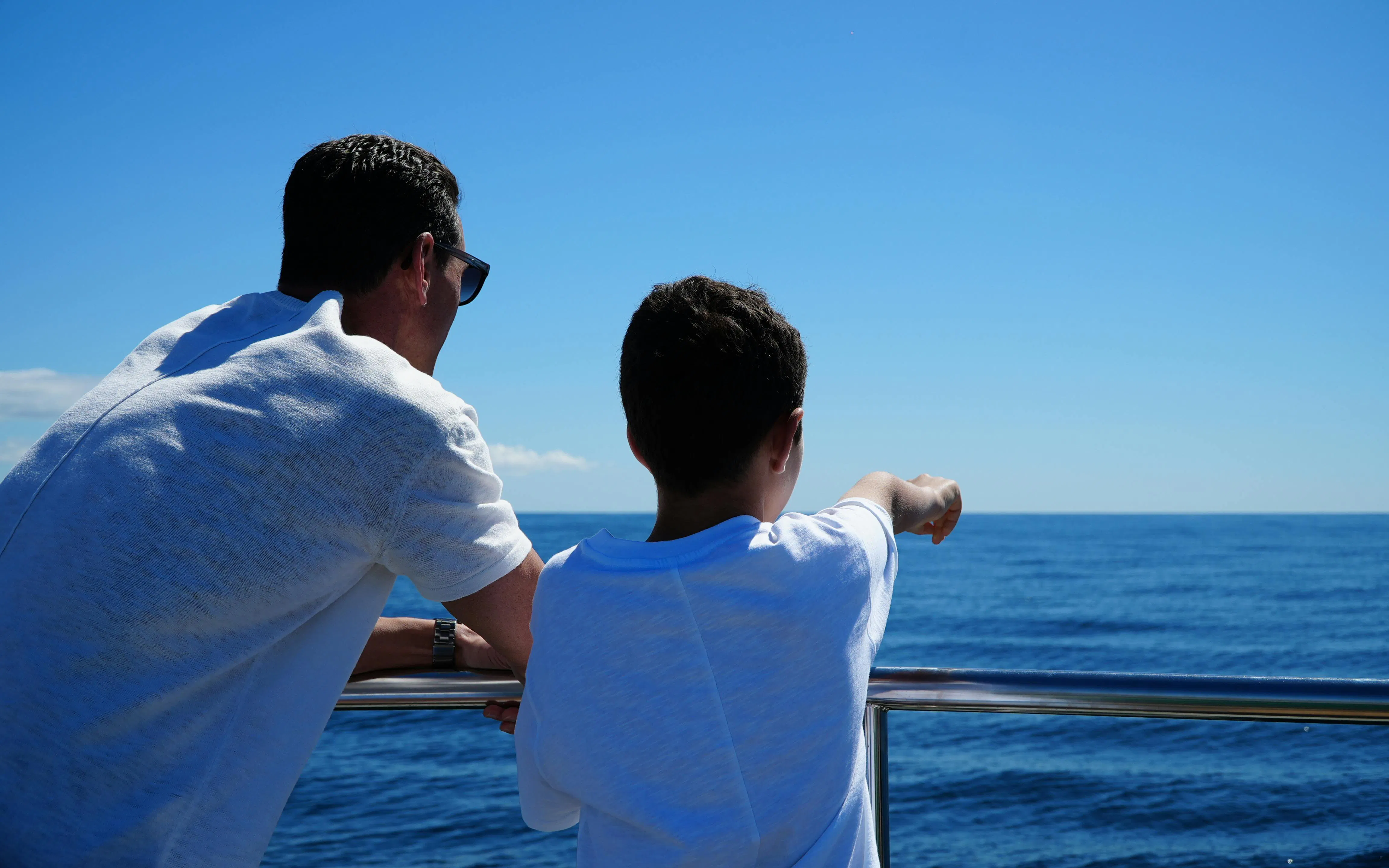 Tourists on a boat watching dolphins near Benagil Caves, Algarve.