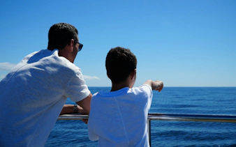 Tourists on a boat watching dolphins near Benagil Caves, Algarve.