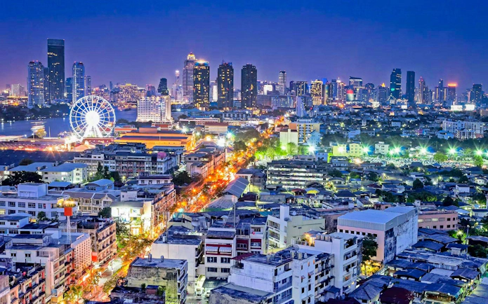 Cityscape with Asiatique Sky Ferris wheel illuminated at night, Bangkok, Thailand.