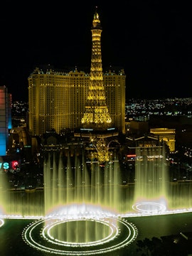 Eiffel Tower replica and fountain show at night, Las Vegas.