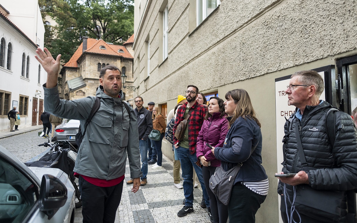 Tour guide leading guests through Jewish Quarters in Prague.