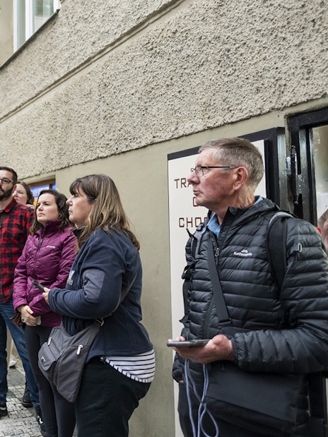 Tour guide leading guests through Jewish Quarters in Prague.