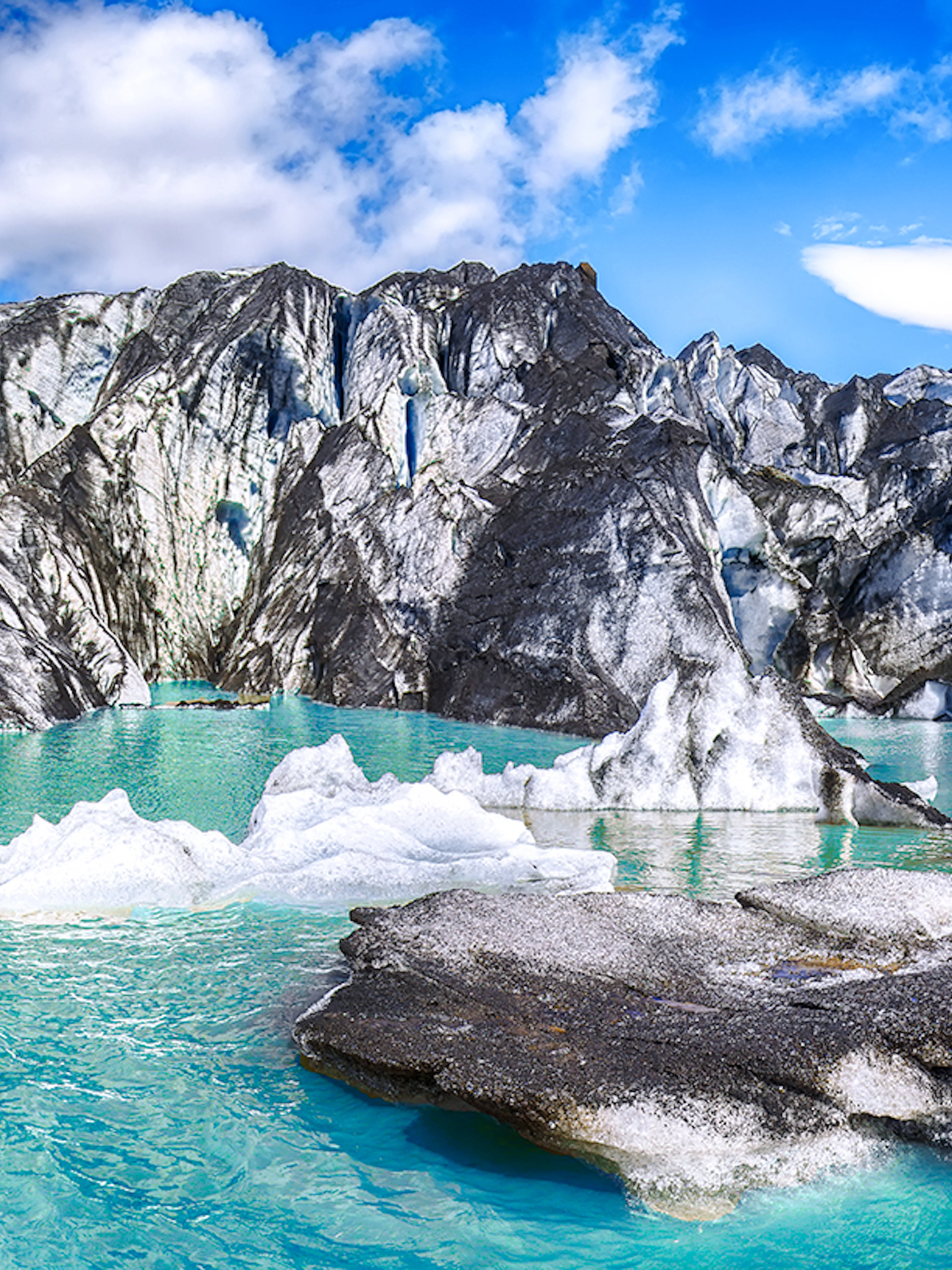 Solheimajokull glacier with turquoise meltwater and ice formations in Iceland.