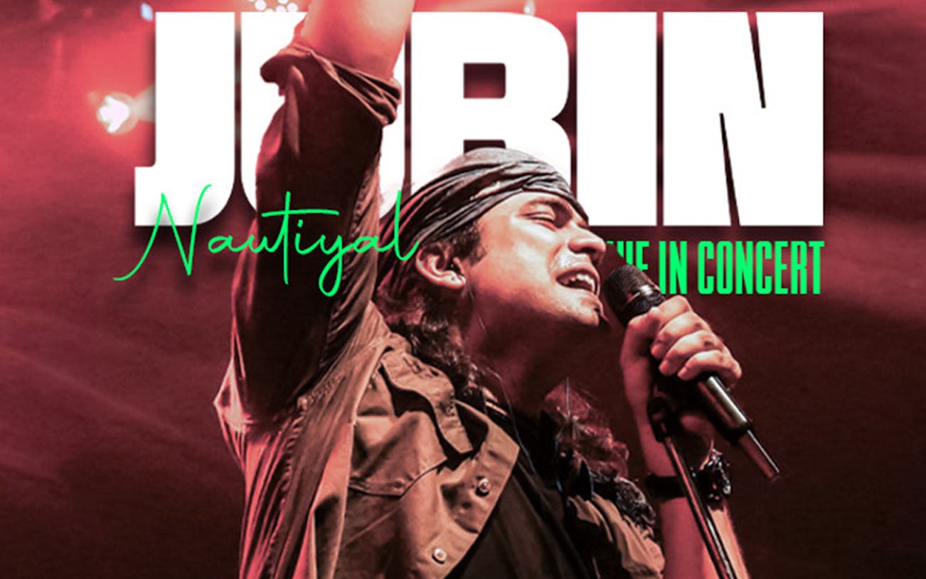 Singer performing at Jubin Nautiyal live concert with microphone in hand.