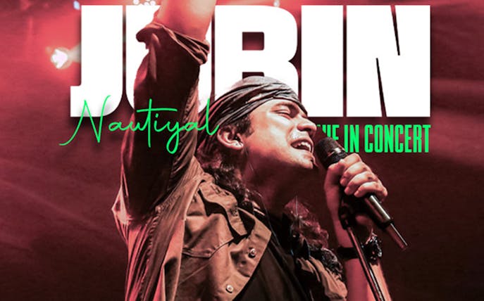 Singer performing at Jubin Nautiyal live concert with microphone in hand.