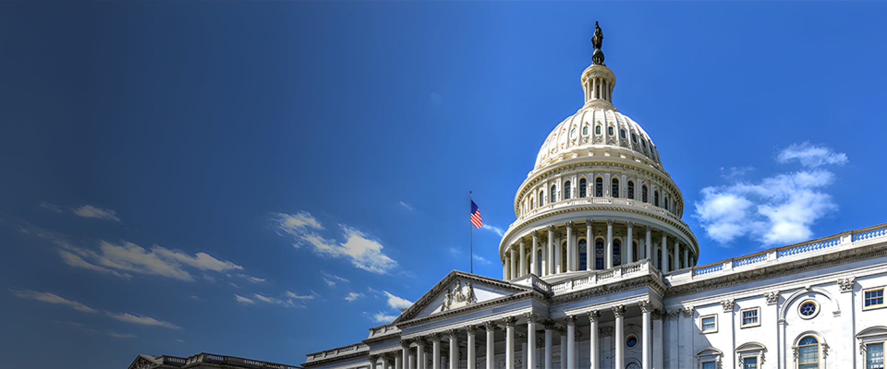 U.S. Capitol building dome with American flag, Washington DC.