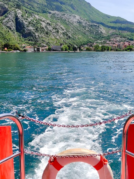 View from semi-submarine of Boka Bay, Kotor, with mountains and shoreline in the background.