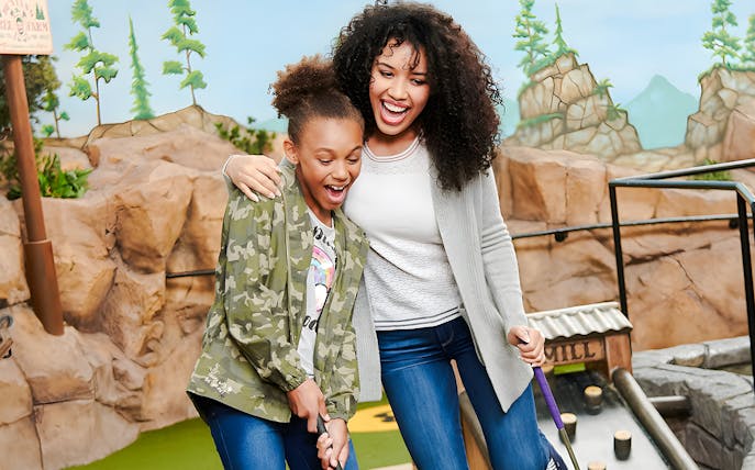 Mother and daughter playing mini-golf at Moose Mountain Adventure Golf, Mall of America.