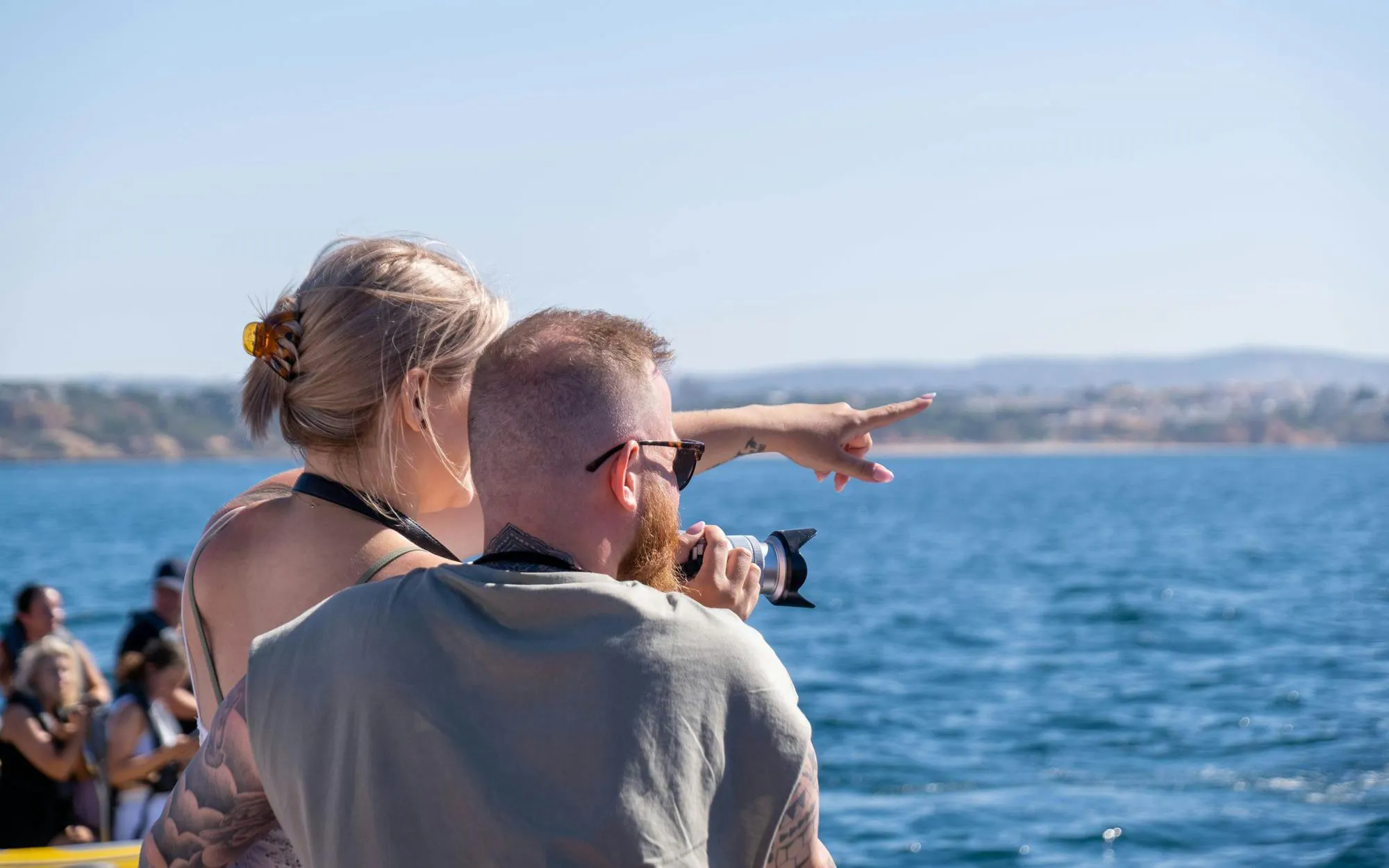 Tourists observing dolphins near Benagil Caves, Algarve.