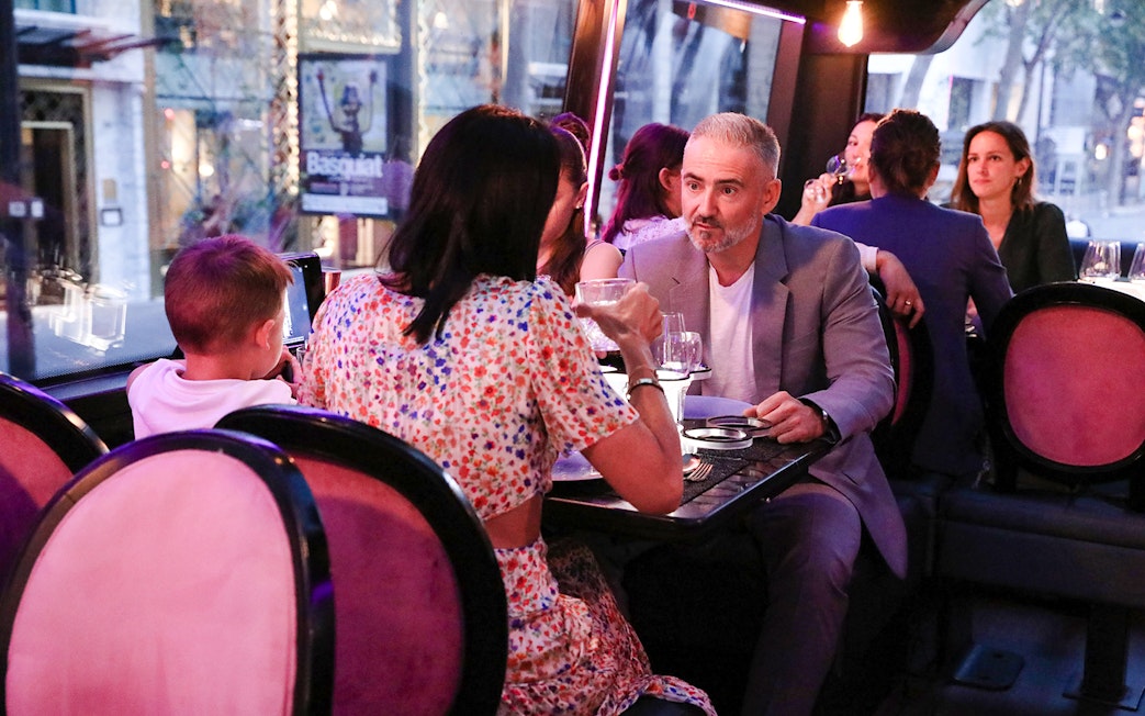 Couple dining inside Bus Toqué in Paris.