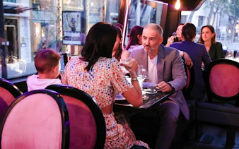 Couple dining inside Bus Toqué in Paris.