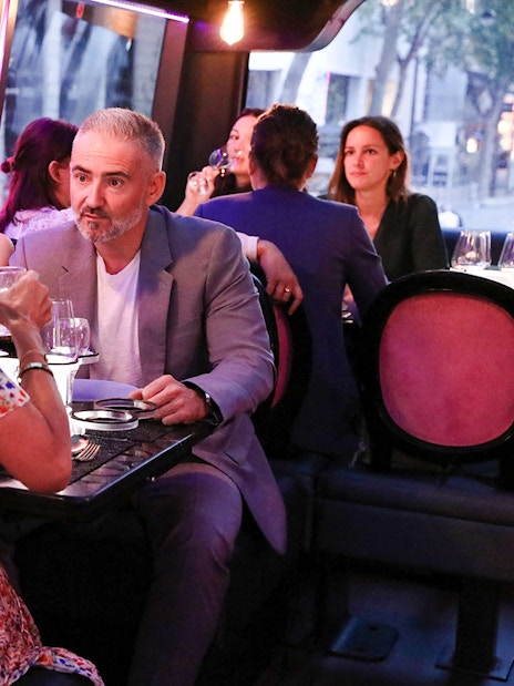 Couple dining inside Bus Toqué in Paris.