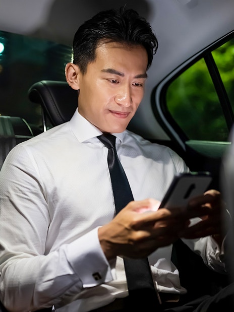Private car transfer passenger using phone from Singapore Changi Airport.