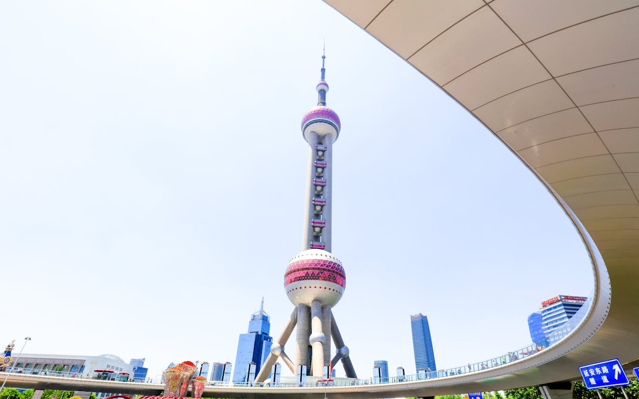 Oriental Pearl TV Tower in Shanghai, China, with surrounding cityscape.