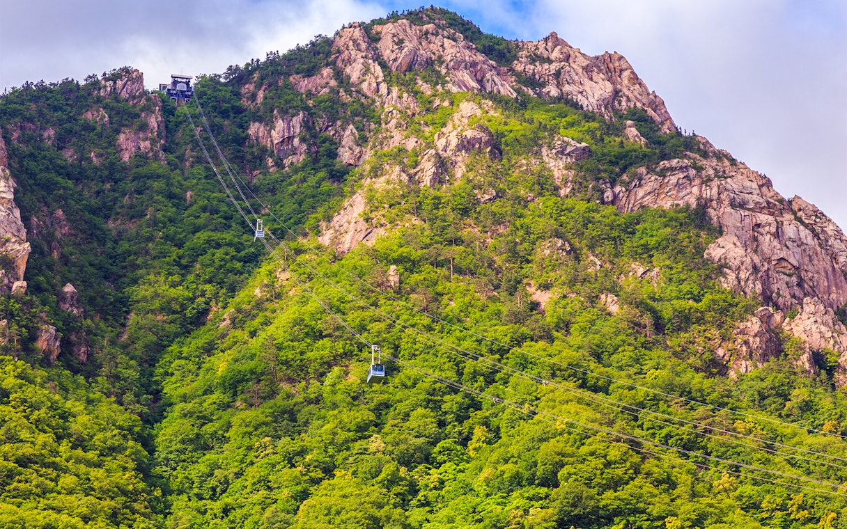 Cable car ascending Mount Seorak with lush greenery, South Korea.
