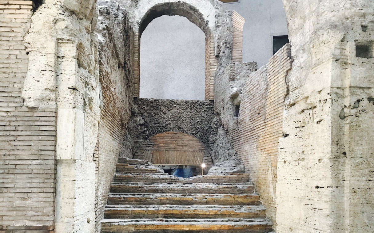 Underground ruins with ancient stone steps in Rome's Navona Square and Trevi District.