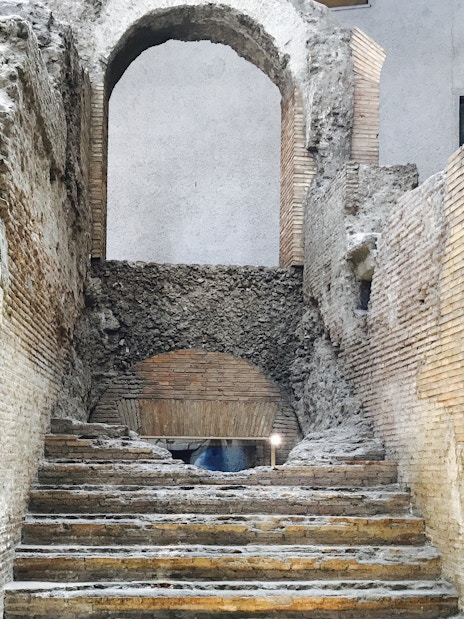 Underground ruins with ancient stone steps in Rome's Navona Square and Trevi District.