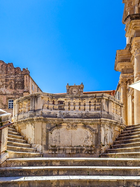 Jesuit Stairs leading to historic buildings in Dubrovnik's city center.