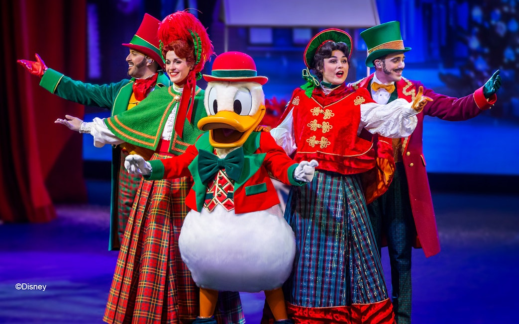 Disney characters performing in a festive musical show at Disneyland Paris.