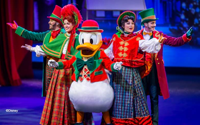 Disney characters performing in a festive musical show at Disneyland Paris.
