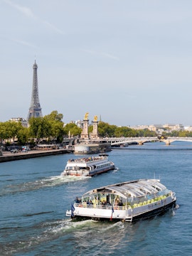 Batobus cruising on the Seine River with Eiffel Tower in the background, Paris.