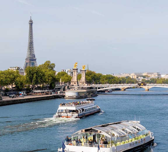Batobus cruising on the Seine River with Eiffel Tower in the background, Paris.
