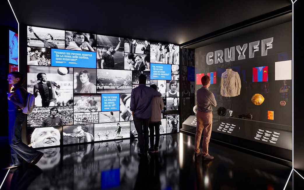 Visitors viewing exhibits at Camp Nou Barca Museum featuring Johan Cruyff memorabilia.