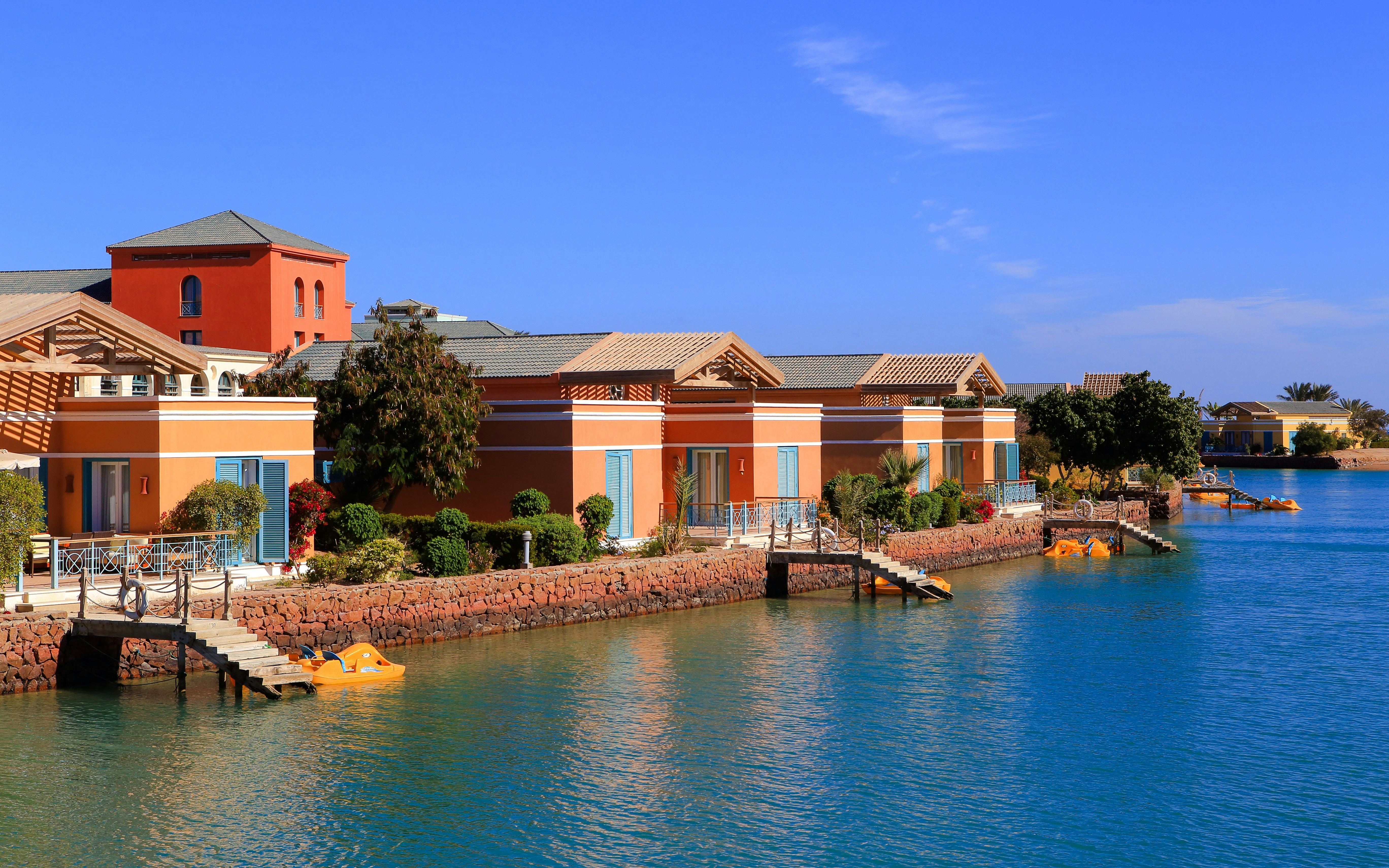 Colorful villas along the waterfront in El Gouna, Hurghada, with clear blue skies.
