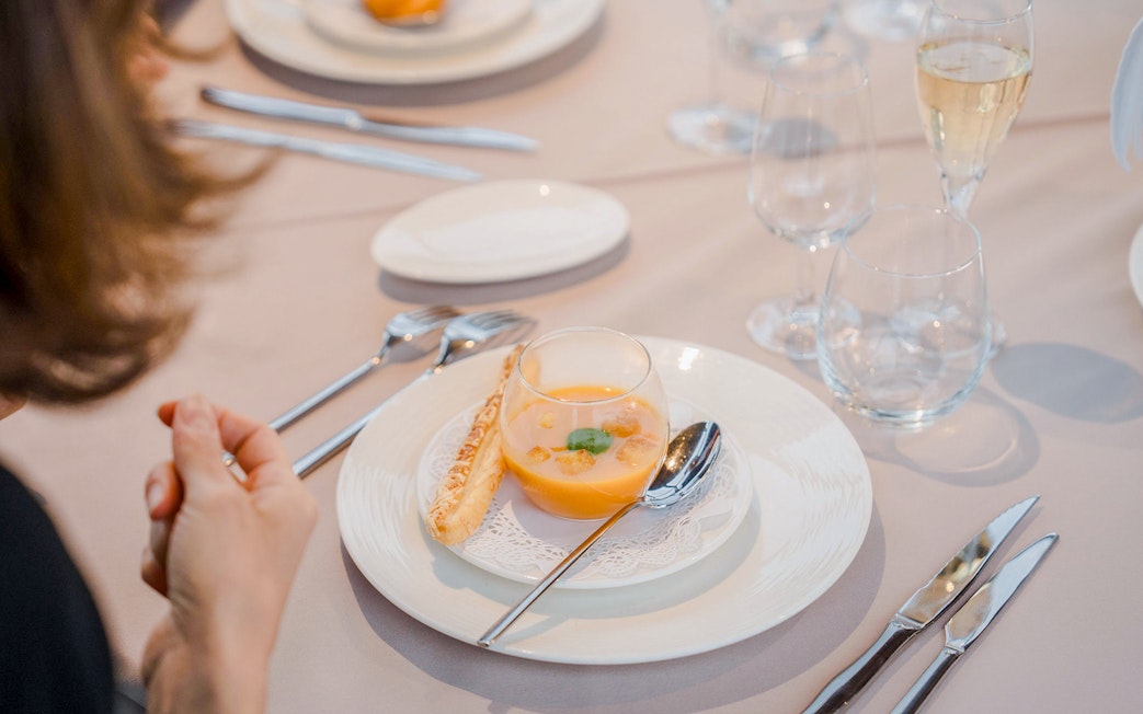 Elegant dining setup with soup and breadstick on Bateaux Mouches cruise.