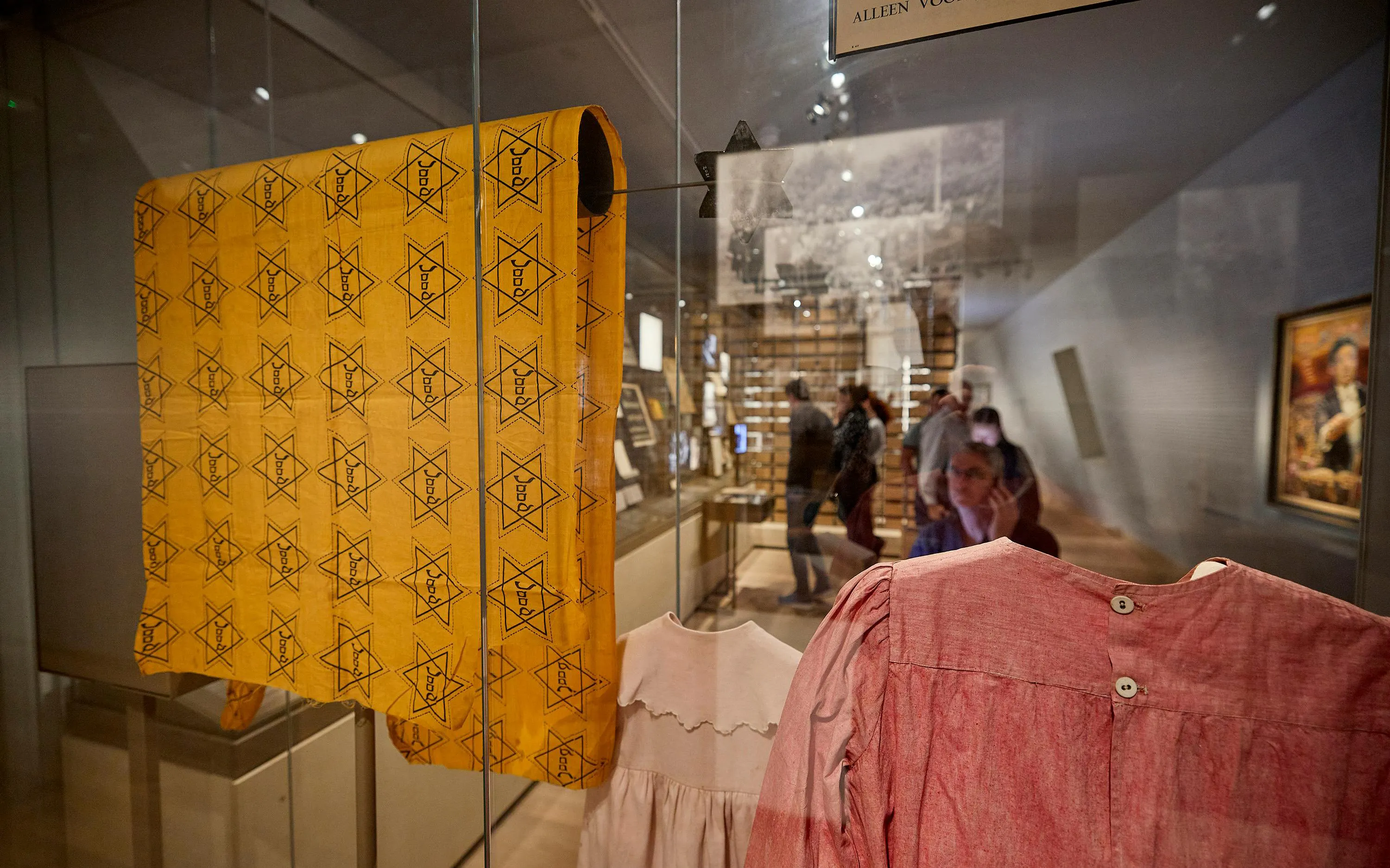 Yellow Star of David cloth and historical garments displayed at the National Holocaust Museum.